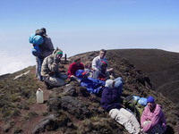 The group sitting huddled at the top of Mount Cameroon